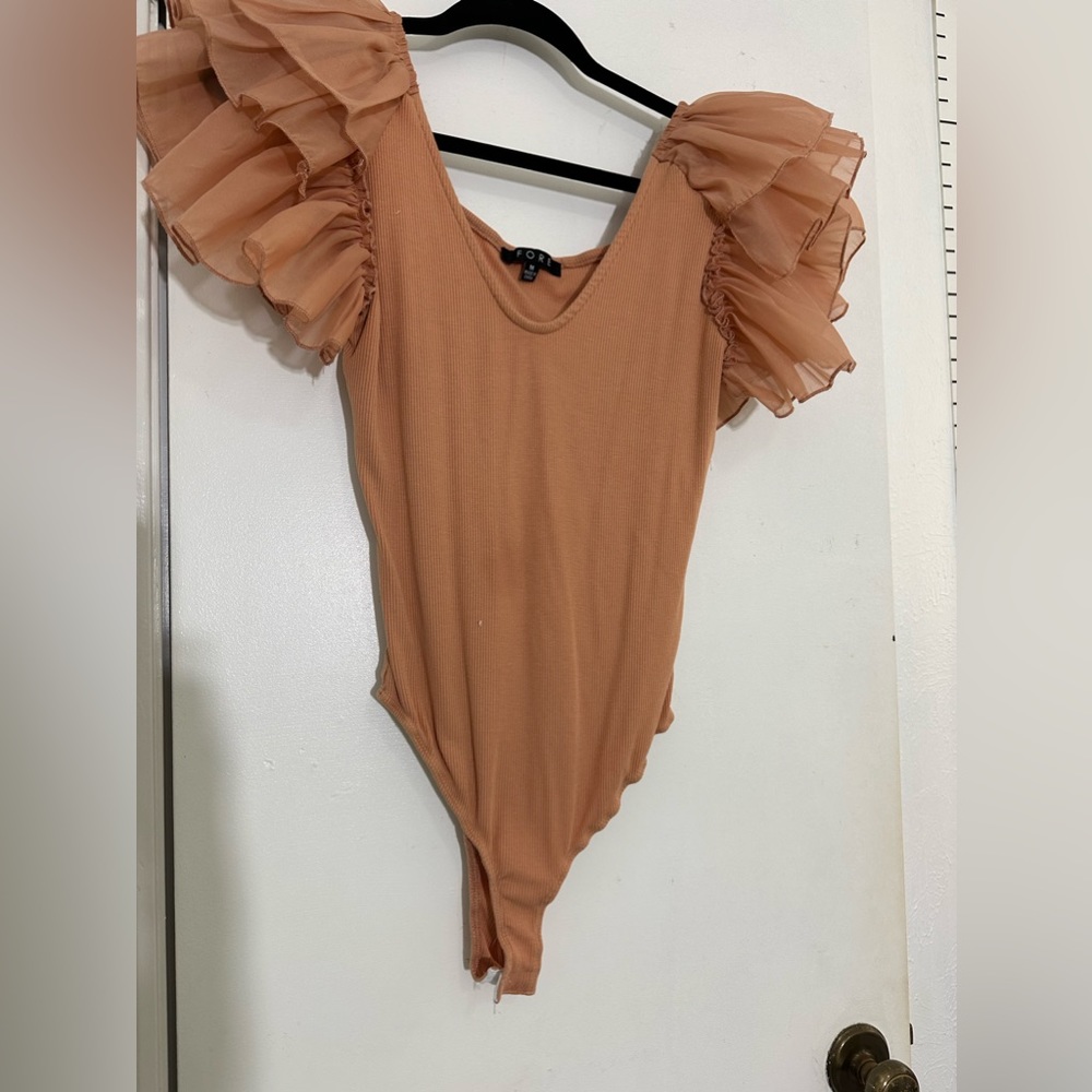 Size medium . Peach body suit. Fits well. True to size